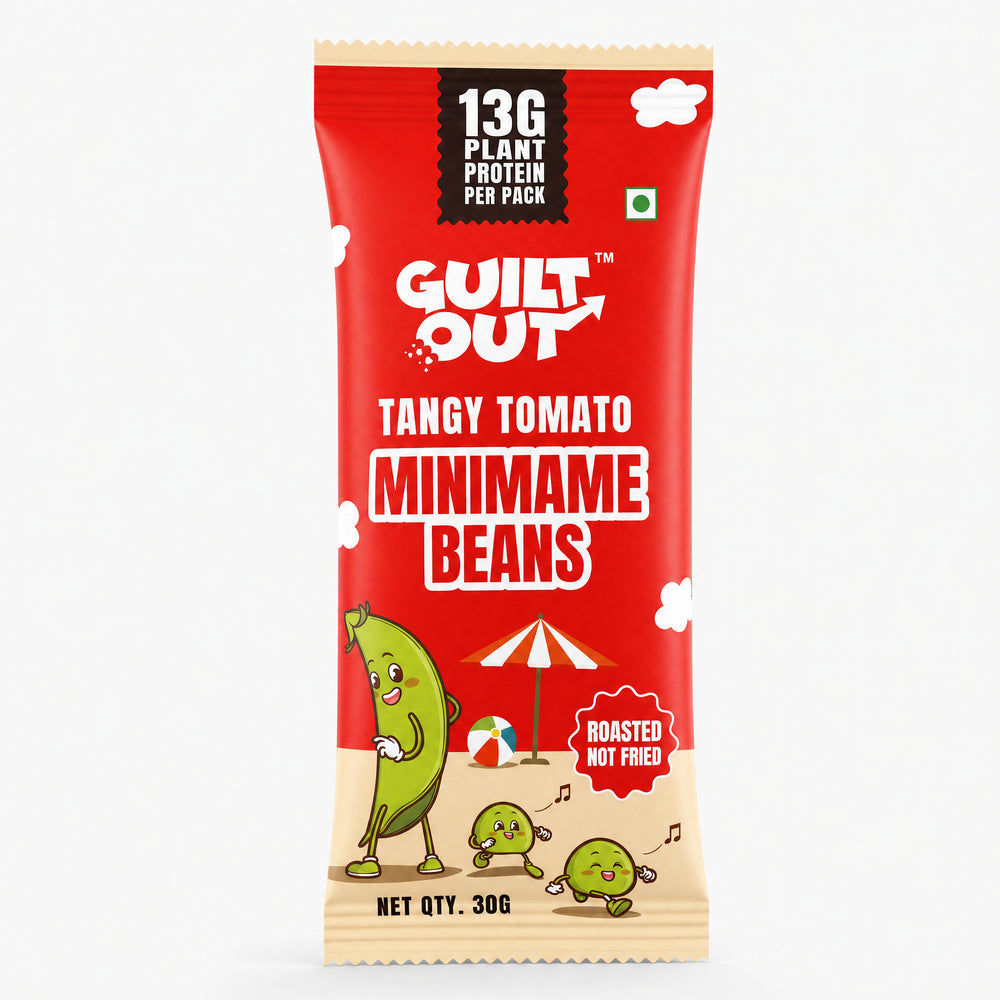 A single packaged snack stick of GUILT OUT Tangy Tomato Minimame Beans on a plain white background. The packaging is predominantly bright red with a beige bottom section, featuring cartoon minimame characters and text indicating 13g plant protein per pack and roasted not fried.